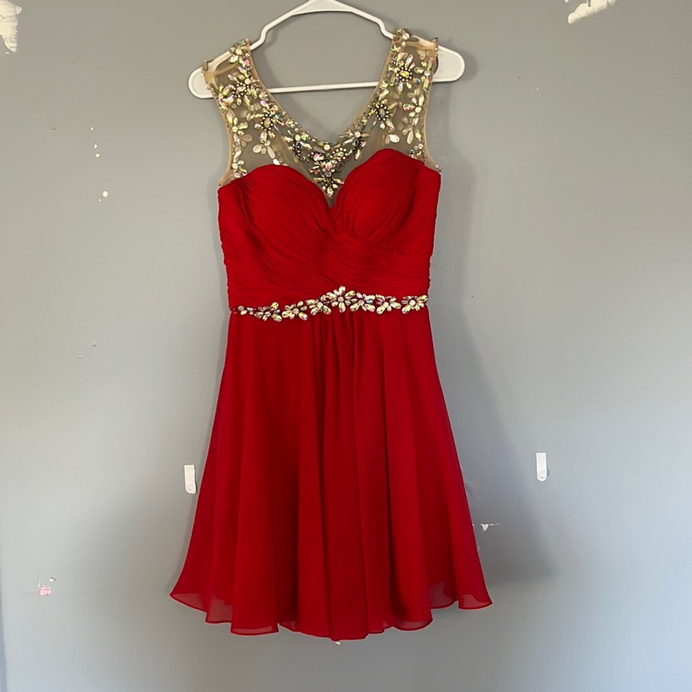 This is a Rachel Allen semi formal dress. Size 12, good condition. Vibrant Red